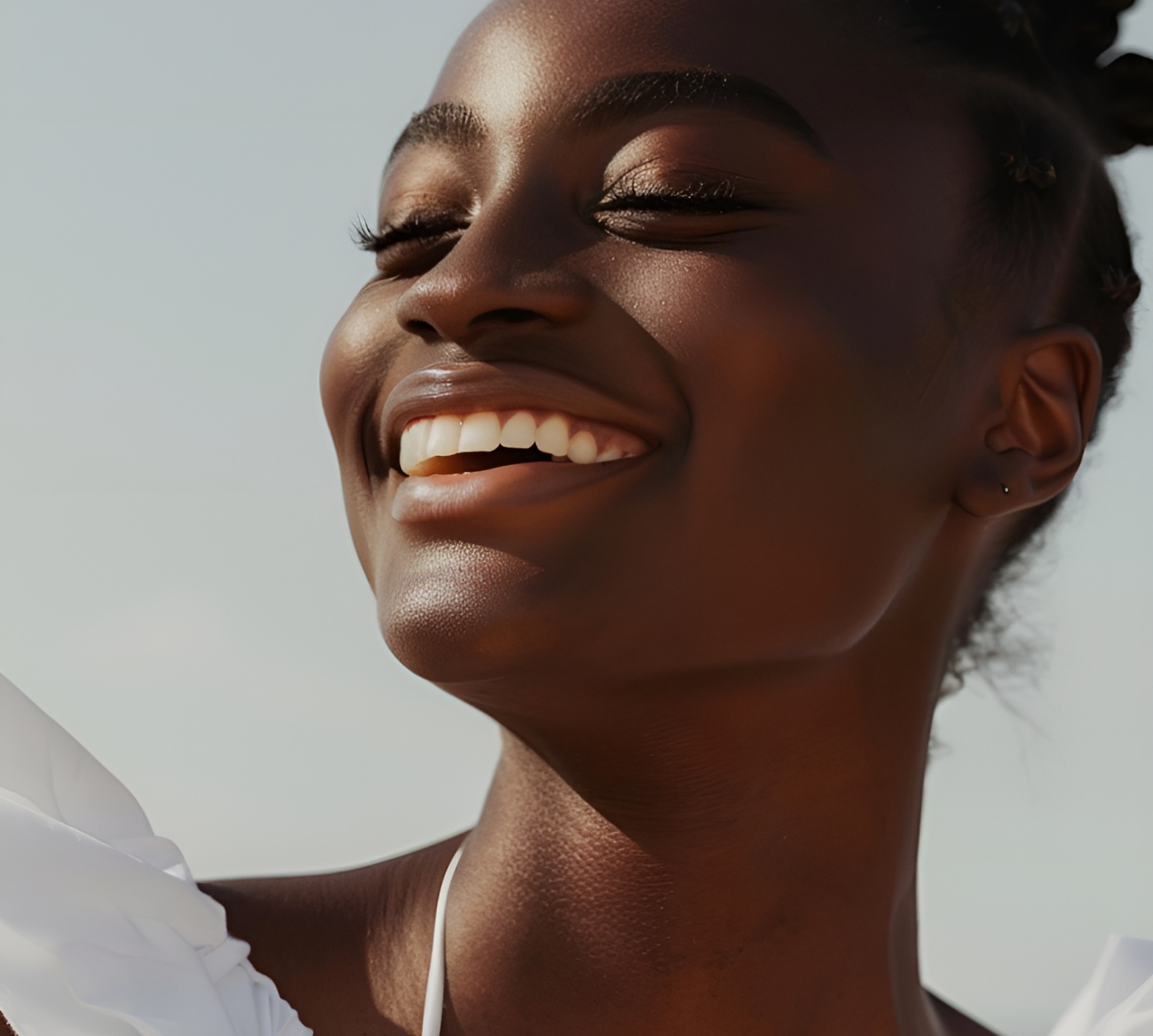 Smiling woman with glowing skin, representing joy and wellness